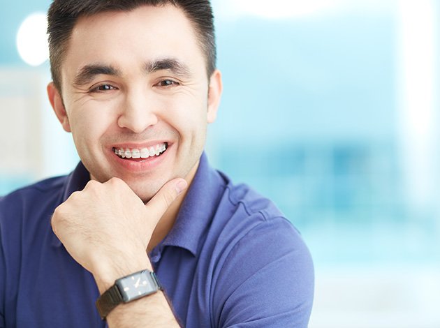 Male patient smiling with clear braces