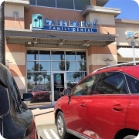 Red car parked in front of pediatric dental office