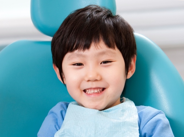 Young boy smiling in dental chair