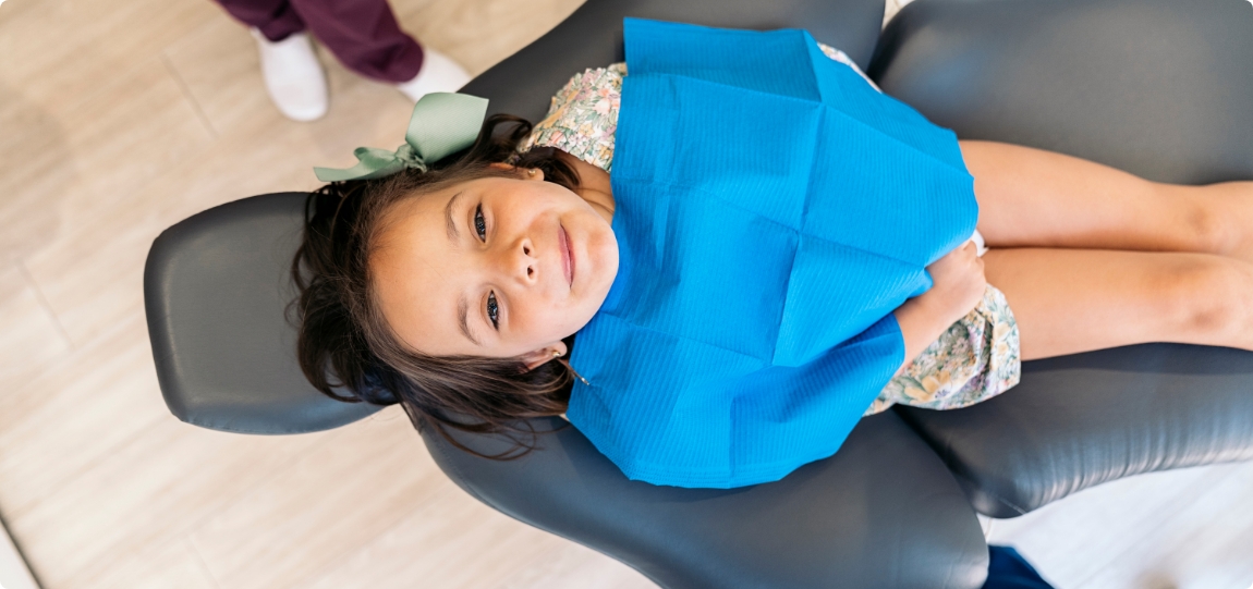Smiling child in dental chair visiting pediatric dentist in San Ramon