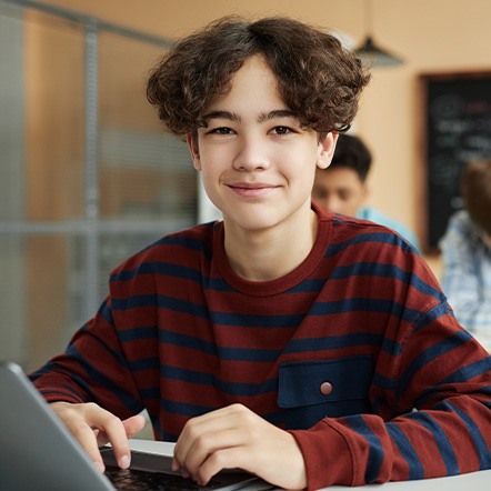 Teen boy smiling in classroom